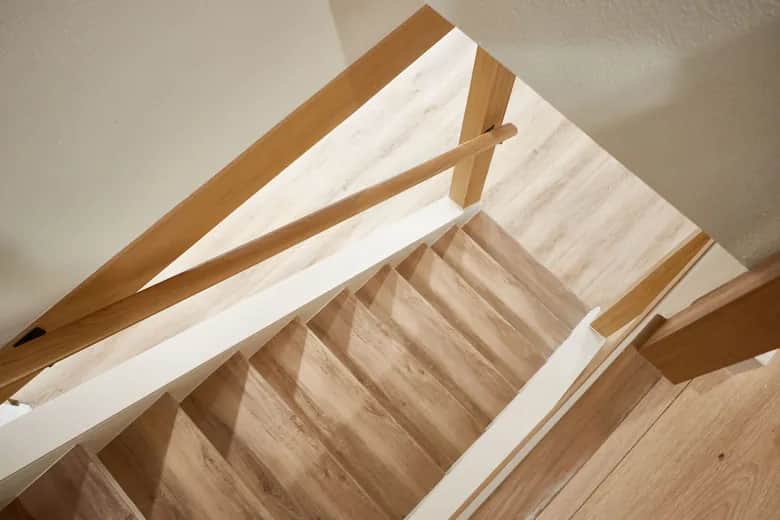 White oak stair treads and a matching wood railing seen from above. Bellevue, WA